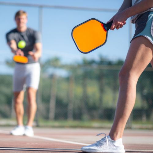 two people playing pickleball