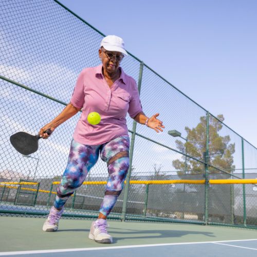 Senior lady playing padel