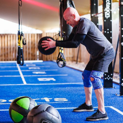 elder man doing ball slams