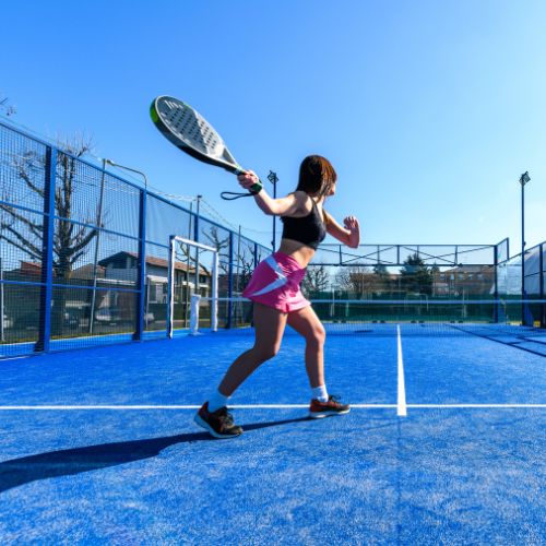 woman playing padel outside