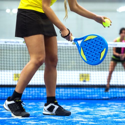 person hitting a padel ball