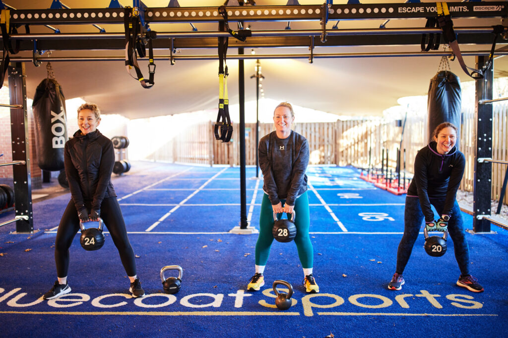 three women working out using kettlebells