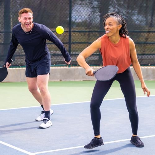 man and woman playing pickleball