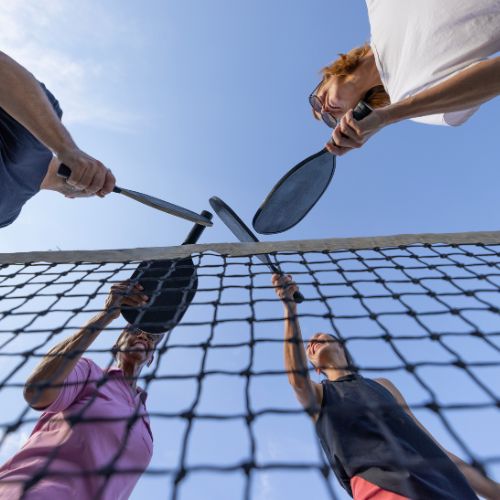 group of people playing pickleball