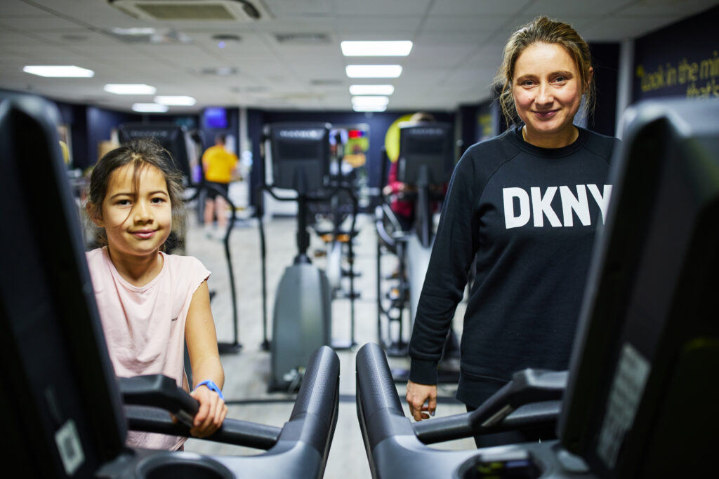 A child and adult woman on the treadmills