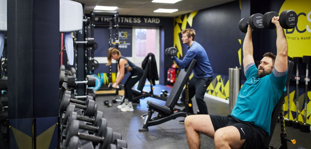 three people using weights